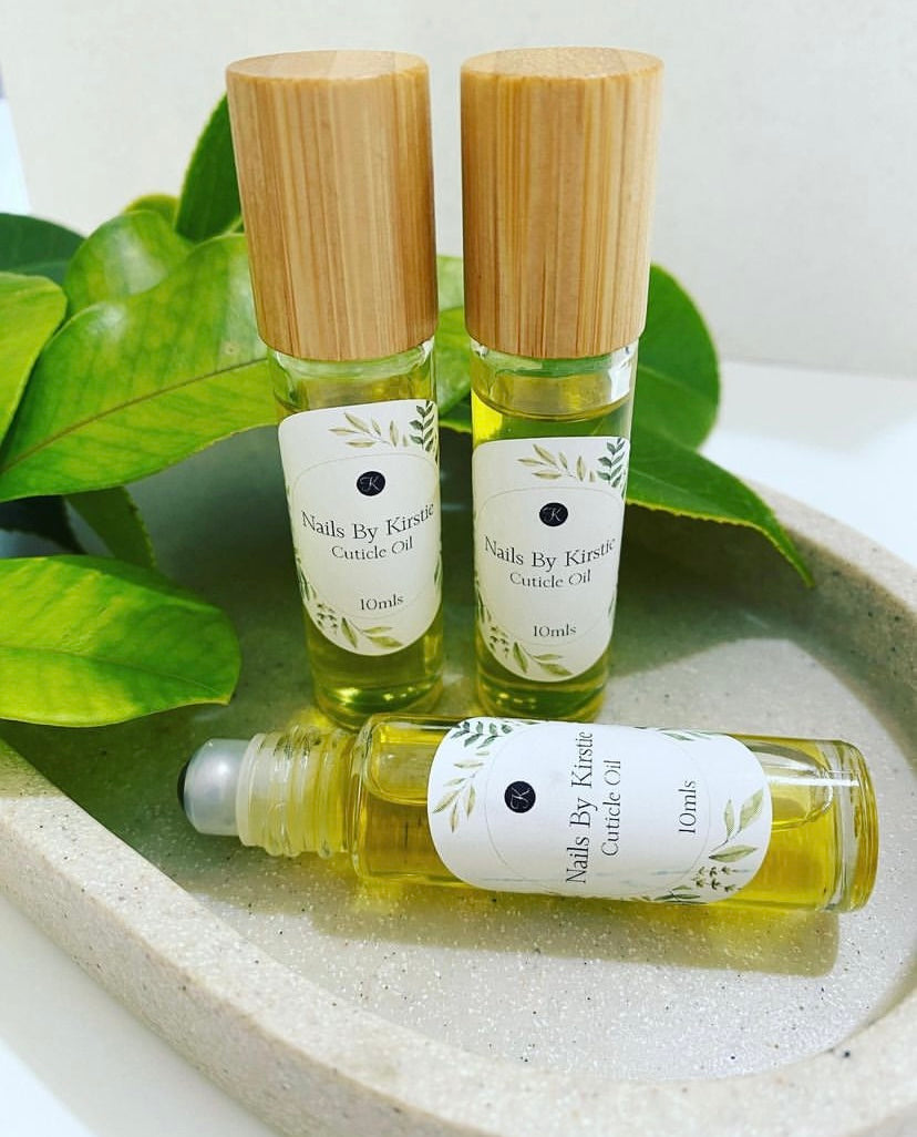 A close-up of glass dropper bottles filled with cuticle oil.