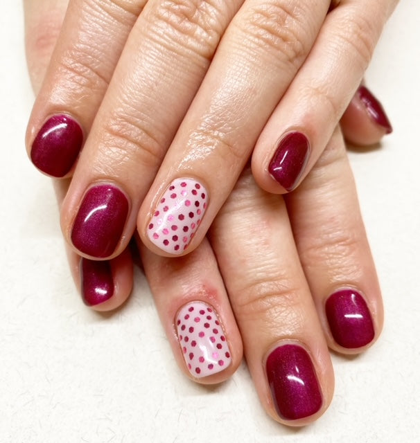 Red nails with polka dot feature nail