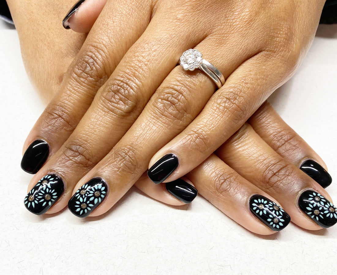 Black nails with floral nail art